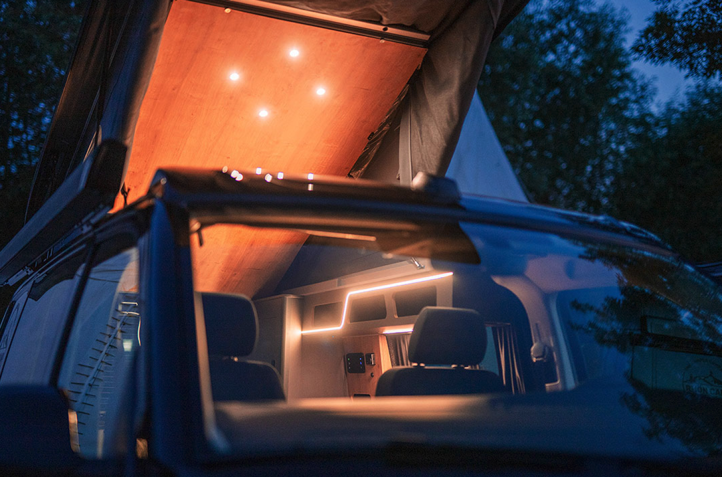 Headliner 2600 pop up camper hanging over a campfire at night